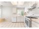 Bright kitchen featuring white cabinetry, tile countertops, and modern appliances, offering a clean and functional space at 4516 Cielo Ln, Las Vegas, NV 89130