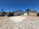 Expansive backyard patio with stone accents, ideal for outdoor entertaining and relaxation at 4823 El Tesoro Ave, Las Vegas, NV 89121