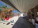 Backyard patio with a swing set and covered area providing shade and recreational space at 4823 El Tesoro Ave, Las Vegas, NV 89121