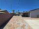 Backyard view with brick fence, leading to a gazebo with seating and the side of the house at 4823 El Tesoro Ave, Las Vegas, NV 89121