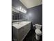 Bathroom featuring a marble vanity with double sinks, shower and toilet at 4823 El Tesoro Ave, Las Vegas, NV 89121