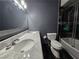 Bathroom featuring a marble vanity with double sinks, shower and toilet at 4823 El Tesoro Ave, Las Vegas, NV 89121