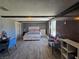 Bedroom with seating area, bed, dresser and wood-look flooring at 4823 El Tesoro Ave, Las Vegas, NV 89121