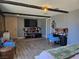 Bedroom with bed, dresser, blue chairs, and wood-look floors at 4823 El Tesoro Ave, Las Vegas, NV 89121
