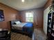 Bedroom with a blue comforter, large window and laminated floors at 4823 El Tesoro Ave, Las Vegas, NV 89121