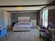 Cozy bedroom features a comfortable bed, wood floors, and a window with natural light at 4823 El Tesoro Ave, Las Vegas, NV 89121