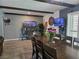 Dining space features a large table and chairs, along with a built-in bookshelf and modern lighting at 4823 El Tesoro Ave, Las Vegas, NV 89121