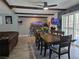 Bright dining area includes a dining table, seating for eight, and backyard access at 4823 El Tesoro Ave, Las Vegas, NV 89121