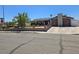 Charming single-story home with stone accents, solar panels, a well-manicured lawn, and a welcoming entrance at 4823 El Tesoro Ave, Las Vegas, NV 89121