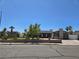 Charming single-story home with stone accents, solar panels, a well-manicured lawn, and a welcoming entrance at 4823 El Tesoro Ave, Las Vegas, NV 89121