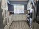 Charming kitchen with updated appliances, white cabinets, and lots of natural light at 4823 El Tesoro Ave, Las Vegas, NV 89121
