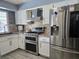 Kitchen featuring tile backsplash, stainless steel appliances, and tiled floor at 4823 El Tesoro Ave, Las Vegas, NV 89121