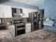 Updated kitchen with stainless steel appliances and stone-style backsplash at 4823 El Tesoro Ave, Las Vegas, NV 89121
