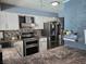 This kitchen features white cabinets, stainless steel appliances, and stone style backsplash at 4823 El Tesoro Ave, Las Vegas, NV 89121