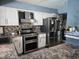 Kitchen showcases white cabinets, stainless steel appliances, and stone-style backsplash at 4823 El Tesoro Ave, Las Vegas, NV 89121