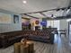 Living room featuring a large leather couch, hardwood flooring, and stone fireplace at 4823 El Tesoro Ave, Las Vegas, NV 89121