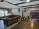 Open concept living room with a large leather couch and hard wood flooring at 4823 El Tesoro Ave, Las Vegas, NV 89121