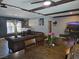 Open concept living room with a large leather couch and hard wood flooring at 4823 El Tesoro Ave, Las Vegas, NV 89121