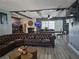Living room featuring a large leather couch and hard wood flooring at 4823 El Tesoro Ave, Las Vegas, NV 89121