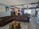 Spacious living room featuring a leather sofa, fireplace, and wood-look floors at 4823 El Tesoro Ave, Las Vegas, NV 89121