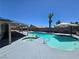Backyard oasis with pool, spa, covered patio, desert landscaping, and palm trees at 4823 El Tesoro Ave, Las Vegas, NV 89121