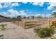 Wide backyard showing a pet enclosure, gravel landscaping, and small trees at 5486 Alfred Dr, Las Vegas, NV 89108