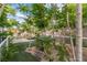 Landscaped backyard featuring turf, trees and rocks, and a playground area at 5486 Alfred Dr, Las Vegas, NV 89108