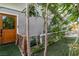 Exterior view of door with nice greenery, turf, and fenced area in the backyard at 5486 Alfred Dr, Las Vegas, NV 89108