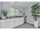 Modern bar area features white cabinetry, black countertops, and hardwood flooring at 5486 Alfred Dr, Las Vegas, NV 89108
