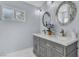 Well-lit bathroom with a double vanity, modern fixtures, and decorative mirrors at 5486 Alfred Dr, Las Vegas, NV 89108