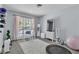 Bright bedroom with gray walls, wood floors, and large windows with seating, perfect for relaxing at 5486 Alfred Dr, Las Vegas, NV 89108
