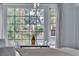 Bright dining area with large windows offering lush outdoor views and modern table set at 5486 Alfred Dr, Las Vegas, NV 89108