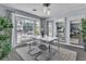 Bright dining room featuring modern lighting and a large window with seating and outside views at 5486 Alfred Dr, Las Vegas, NV 89108