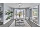 Bright dining area featuring modern lighting, large mirror and a large window with exterior views at 5486 Alfred Dr, Las Vegas, NV 89108