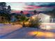 Backyard view of single-story home with desert landscaping and mature trees at 5486 Alfred Dr, Las Vegas, NV 89108