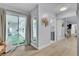 Inviting hallway featuring wood floors, decorative mirror, and slider to a covered outdoor space at 5486 Alfred Dr, Las Vegas, NV 89108