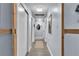 Bright hallway with wood-look flooring, recessed lighting, and white doors offers access to various rooms at 5486 Alfred Dr, Las Vegas, NV 89108