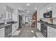 Spacious eat-in kitchen with stainless appliances, brick accent wall, and modern countertops at 5486 Alfred Dr, Las Vegas, NV 89108