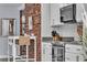 Kitchen featuring stainless steel appliances, a breakfast bar, and brick accent wall at 5486 Alfred Dr, Las Vegas, NV 89108