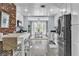 Eat-in kitchen features stainless appliances, white cabinets, breakfast bar, and view to dining room at 5486 Alfred Dr, Las Vegas, NV 89108
