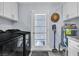 Functional laundry room with modern washer and dryer, storage cabinets, and exterior door at 5486 Alfred Dr, Las Vegas, NV 89108
