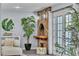 Cozy living room with a brick fireplace, large windows, and comfortable seating at 5486 Alfred Dr, Las Vegas, NV 89108