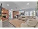 Spacious living room with a brick fireplace, neutral walls, and hardwood flooring at 5486 Alfred Dr, Las Vegas, NV 89108
