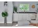 Bright living room with white cabinets, a wet bar, and comfortable seating at 5486 Alfred Dr, Las Vegas, NV 89108