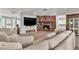 Spacious living room with brick fireplace, built-in shelving, and comfortable sectional sofa at 5486 Alfred Dr, Las Vegas, NV 89108