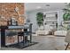 Stylish living room with brick accents, a piano, and comfortable seating at 5486 Alfred Dr, Las Vegas, NV 89108