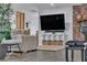 Living room featuring a brick accent wall and a large television at 5486 Alfred Dr, Las Vegas, NV 89108