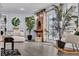 Inviting living room with exposed brick fireplace, stylish decor, and natural light through French doors at 5486 Alfred Dr, Las Vegas, NV 89108