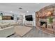 Inviting living room features a brick fireplace, hardwood floors, and modern decor at 5486 Alfred Dr, Las Vegas, NV 89108