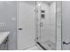 Modern bathroom featuring a walk-in shower with glass doors and tiled walls at 5486 Alfred Dr, Las Vegas, NV 89108